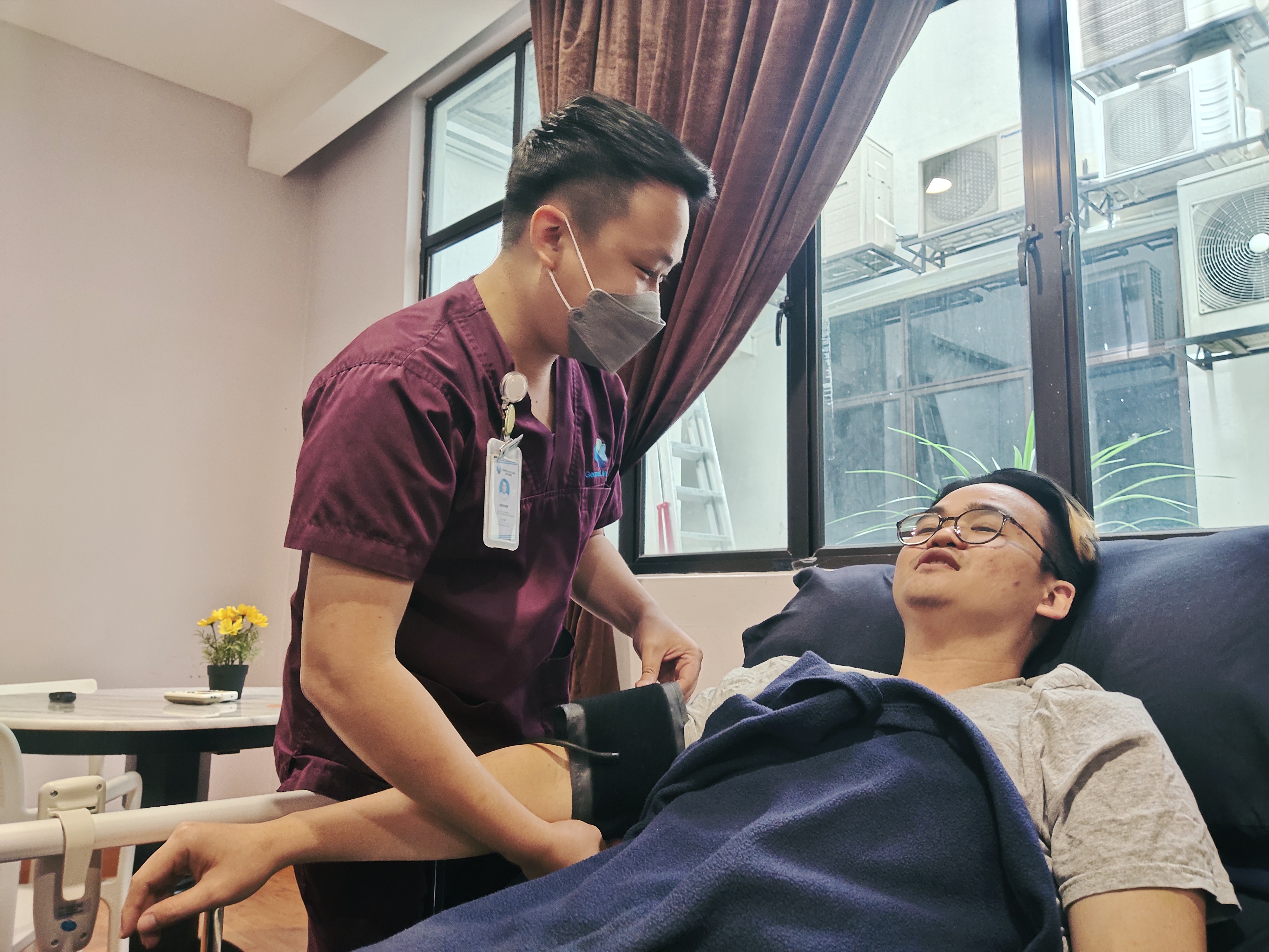 Nurse monitoring patient vital signs